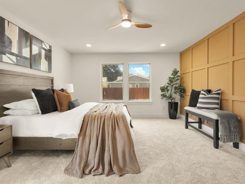 Bedroom featuring light colored carpet and ceiling fan