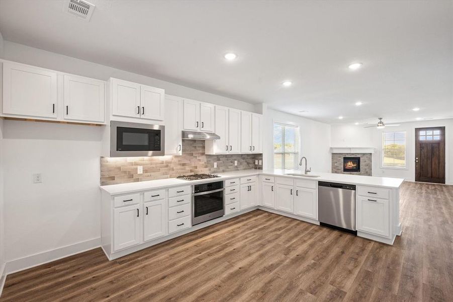 Kitchen with breakfast bar and tile backsplash