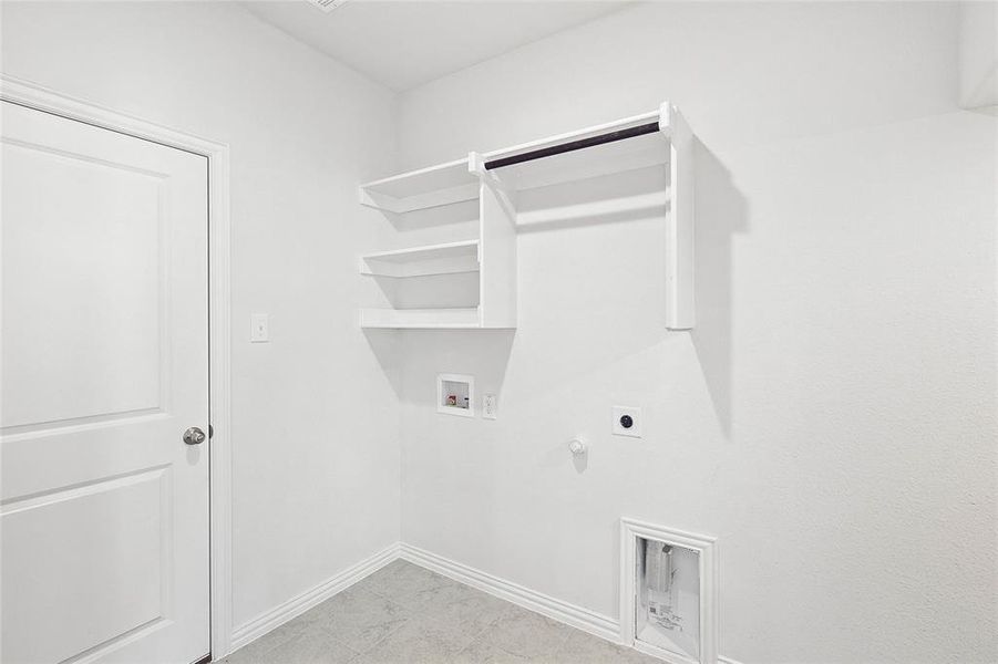 Laundry room with light tile floors, washer hookup, electric dryer hookup, and hookup for a gas dryer