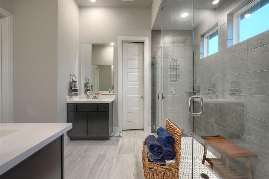 Bathroom featuring vanity and a shower with door