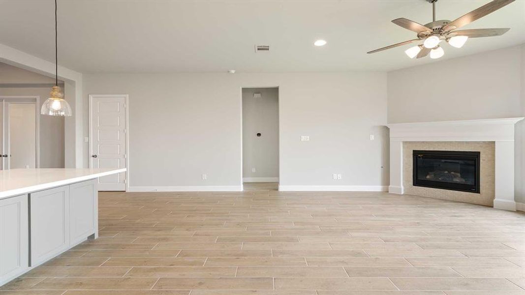 Unfurnished living room with light hardwood / wood-style flooring and ceiling fan