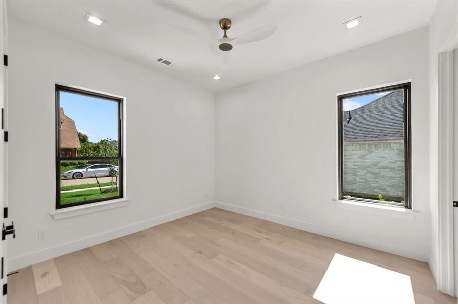 Secondary Bedroom on 1st floor with light hardwood / wood-style floors and ceiling fan