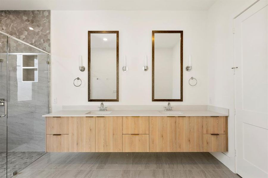 Bathroom with a shower with shower door and vanity