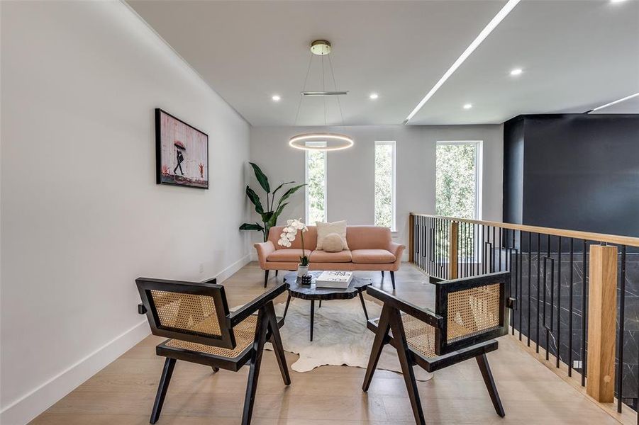 Sitting room with light hardwood / wood-style floors