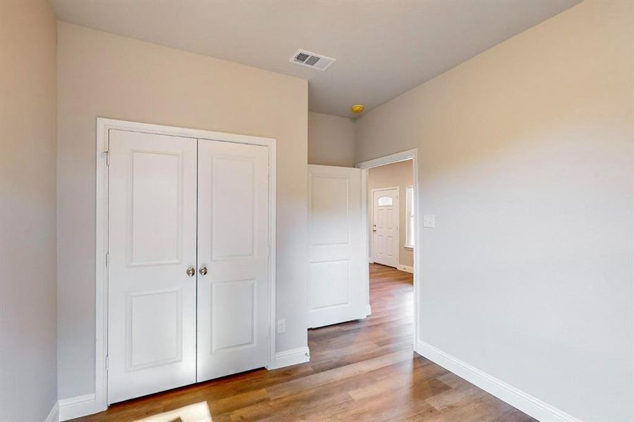 Unfurnished bedroom featuring light hardwood / wood-style flooring and a closet