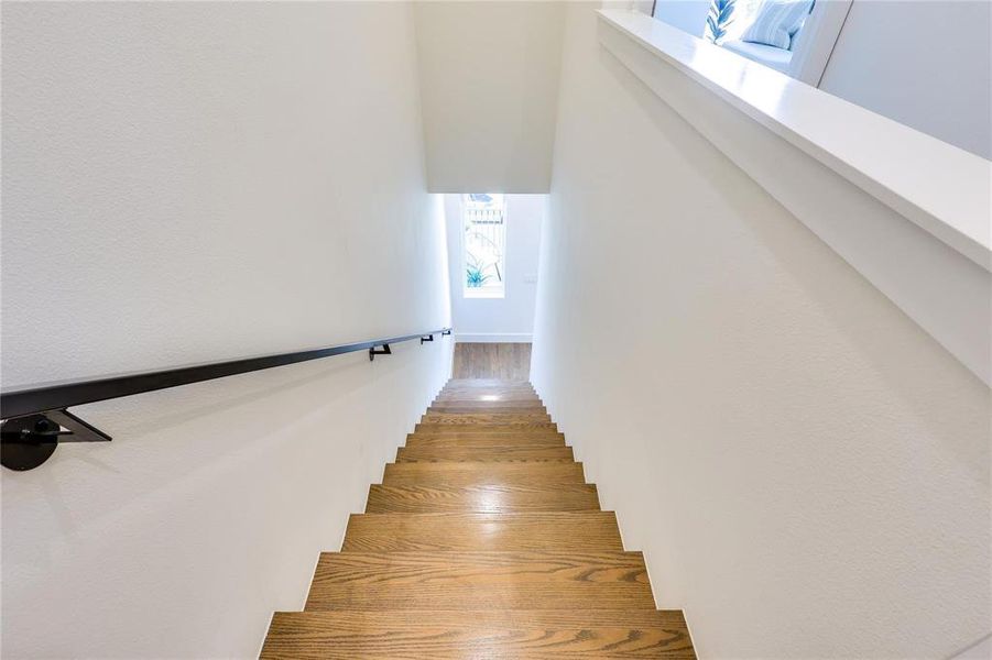 Stairway featuring wood-type flooring