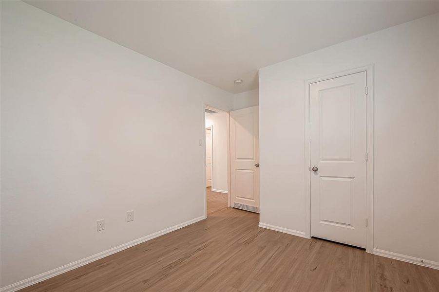 From another angle, the second guest bedroom showcases its roomy closet, adding to the comfort and functionality of this inviting space.