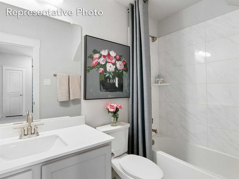 Full bathroom with vanity, toilet, and shower / tub combo with curtain