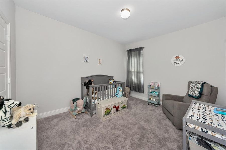 Carpeted bedroom with a crib