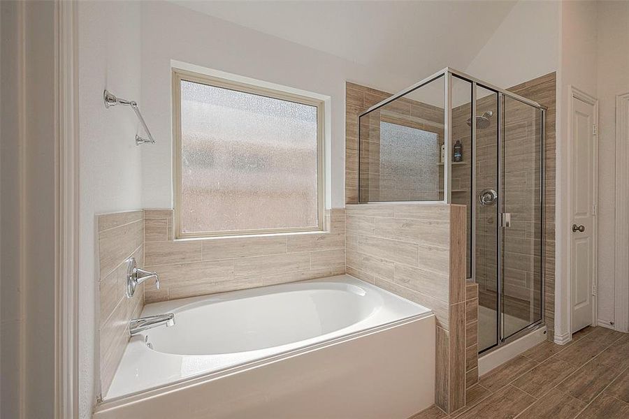The soaking tub and spacious shower offer a variety of options for relaxation.