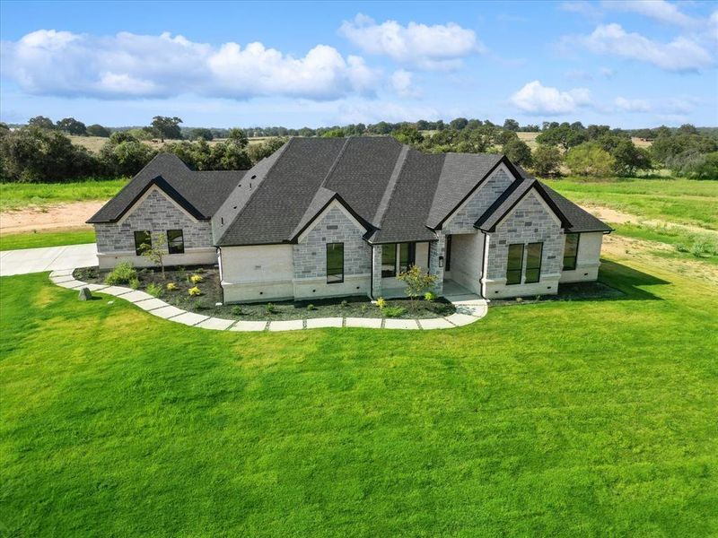 French country home featuring a front yard