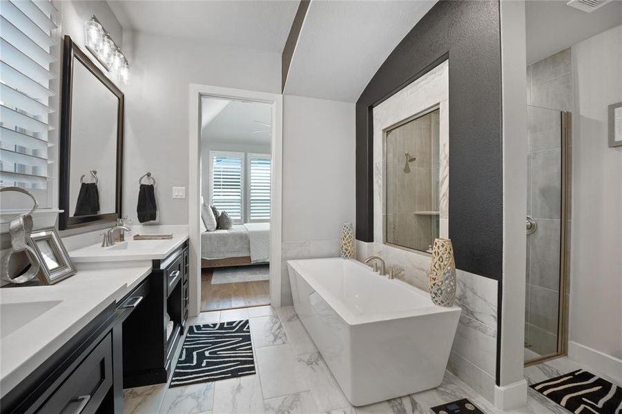 Bathroom with vanity, lofted ceiling, and plus walk in shower