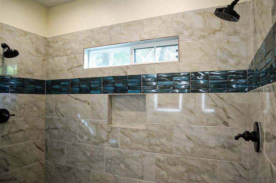 Bathroom featuring a tile shower