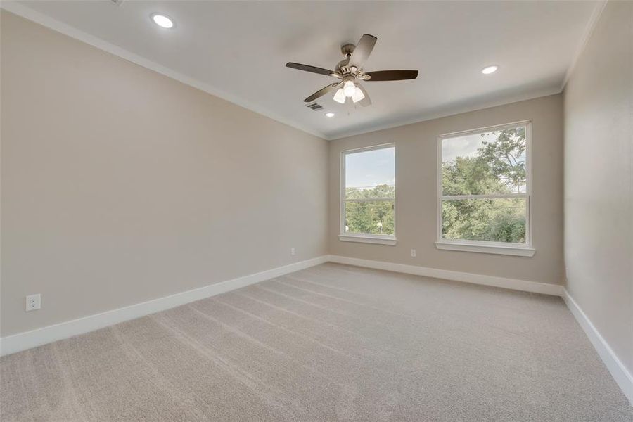 Carpeted empty room with ornamental molding and ceiling fan