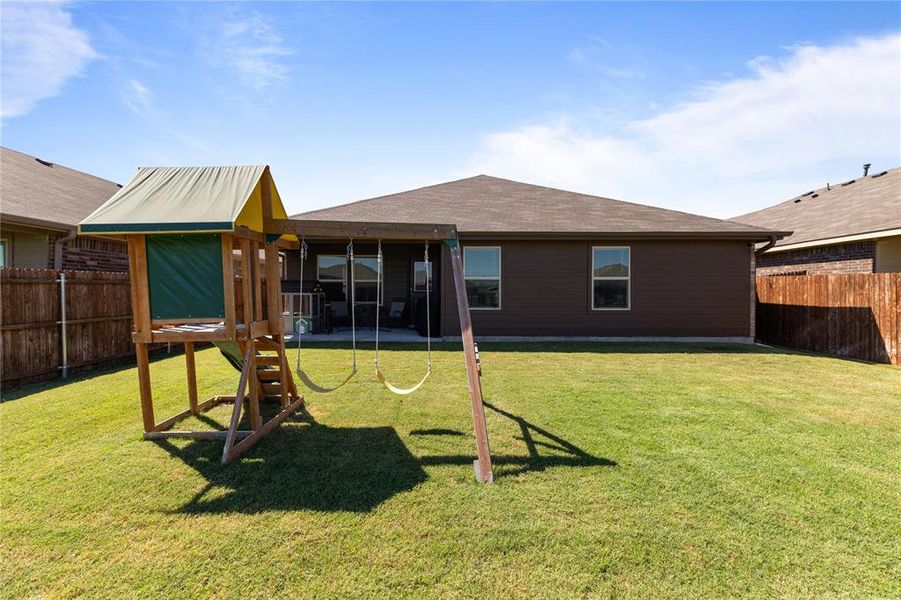 Rear view of property featuring a lawn