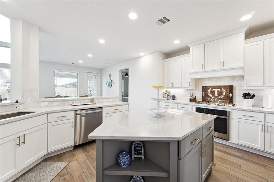 Stainless steel finish appliances and an undermount composite sink are other kitchen features.