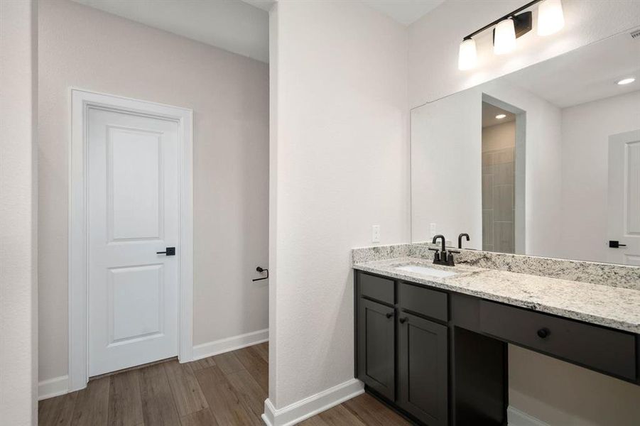 The master bathroom is spacious and has a counter with a spot for a vanity bench or ottoman to make getting ready for a night out very relaxing.
