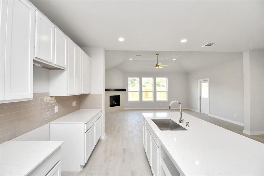 Discover another perspective of this stunning kitchen, generously appointed with an abundance of counter space.