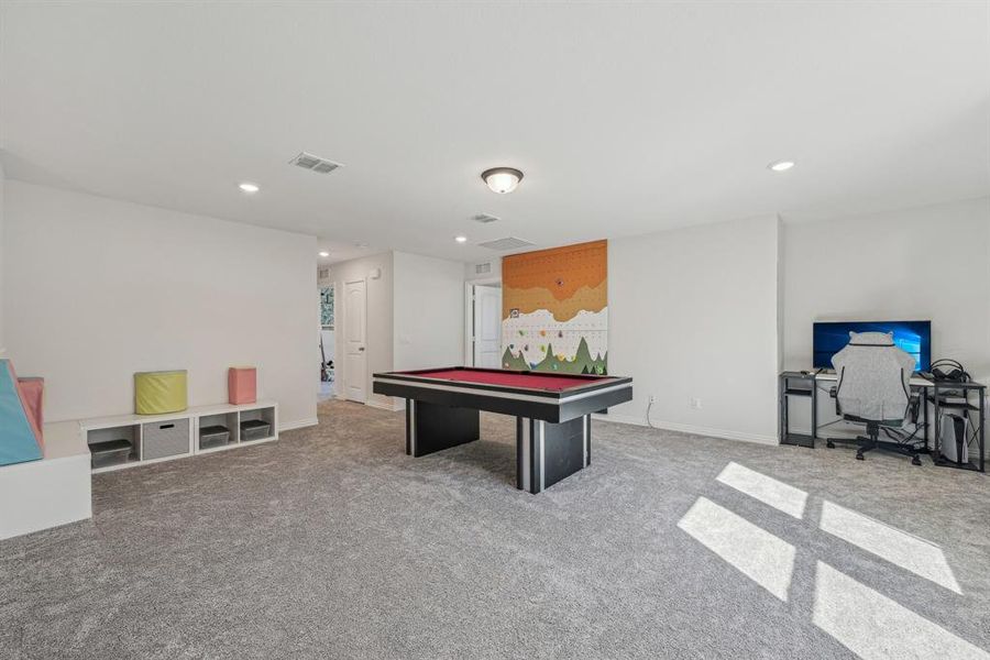 Recreation room with pool table and carpet