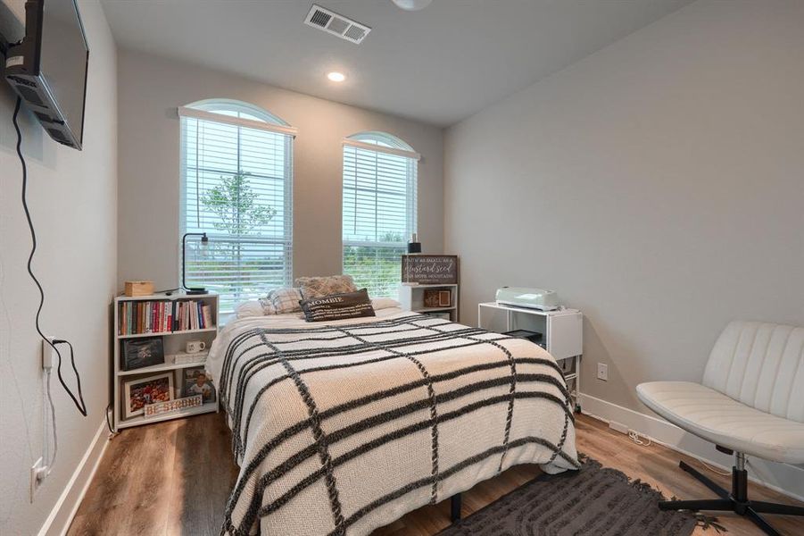 Bedroom featuring wood-type flooring