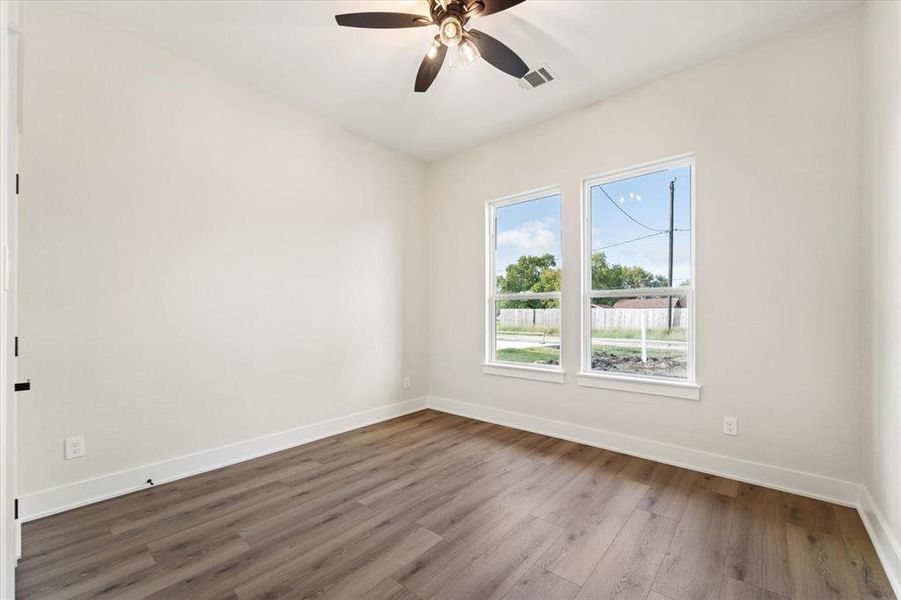 Bedroom 2 features 2 forward facing windows, a ceiling fan and a custom closet.