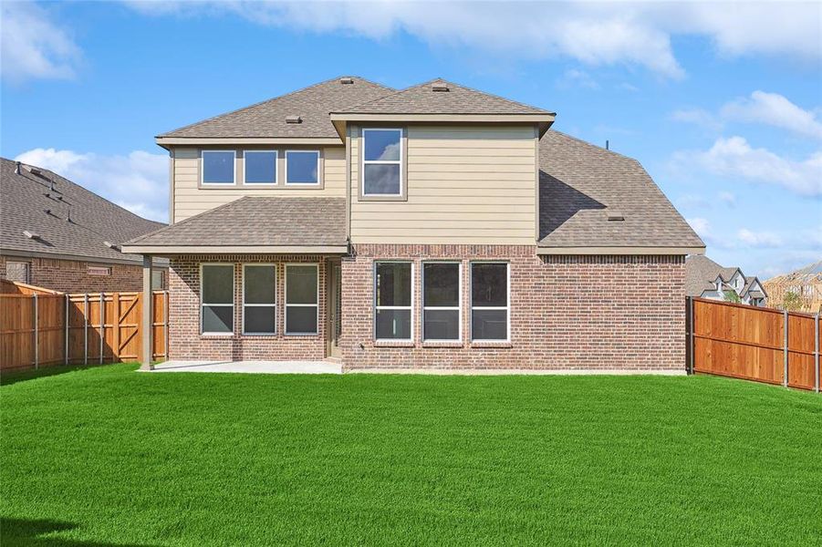 Rear view of house with a patio area and a yard