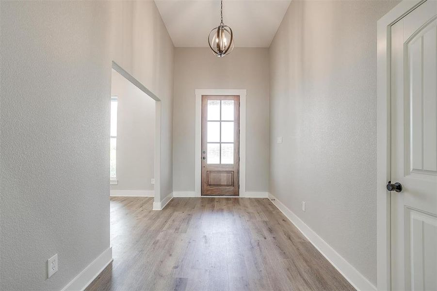 Entryway with a chandelier and light hardwood / wood-style flooring