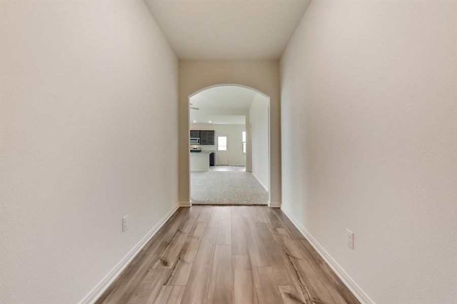 Corridor with hardwood / wood-style flooring