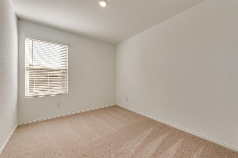 Unfurnished room featuring light colored carpet