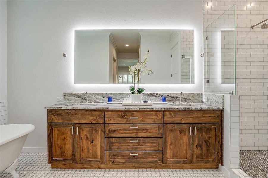 Luxurious master bath with a clawfoot tub, walk-in shower, creating a spa-like atmosphere.