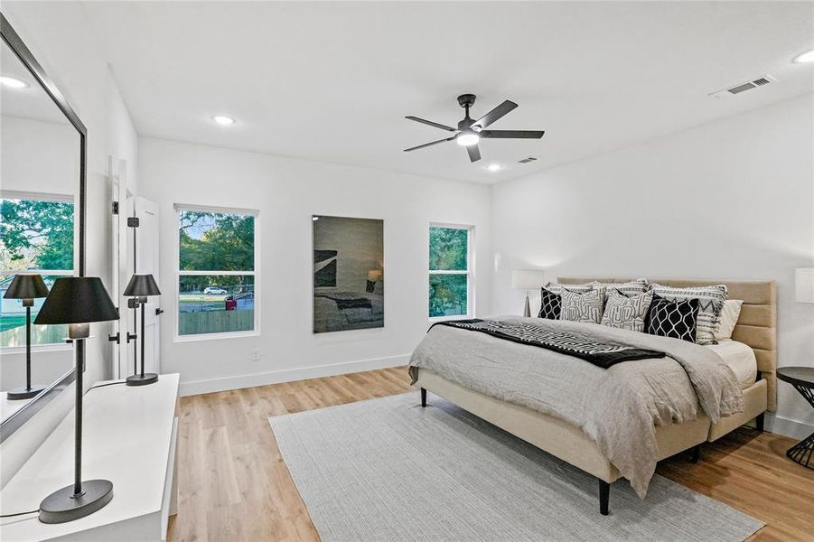 Bedroom with ceiling fan and light hardwood / wood-style floors