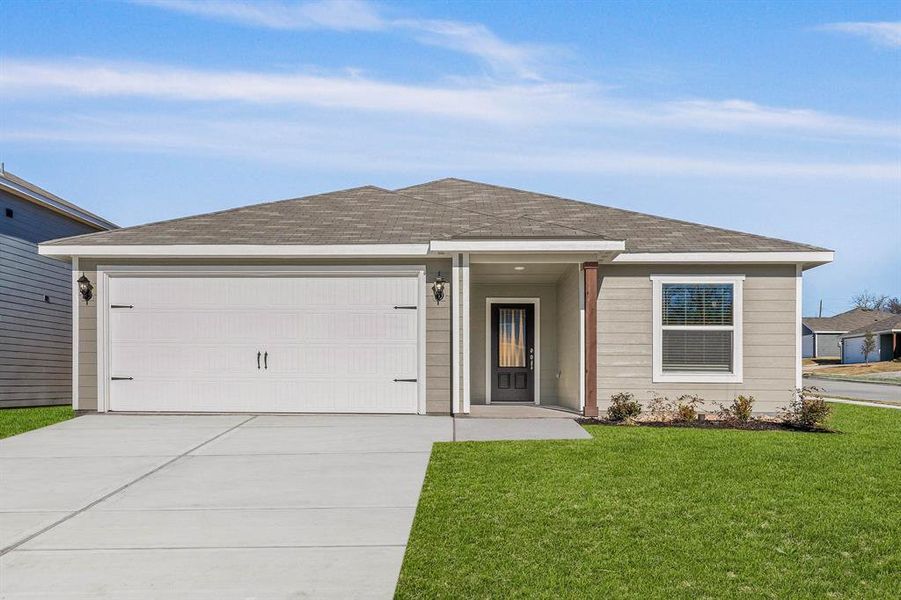 Ranch-style home featuring a garage and a front lawn