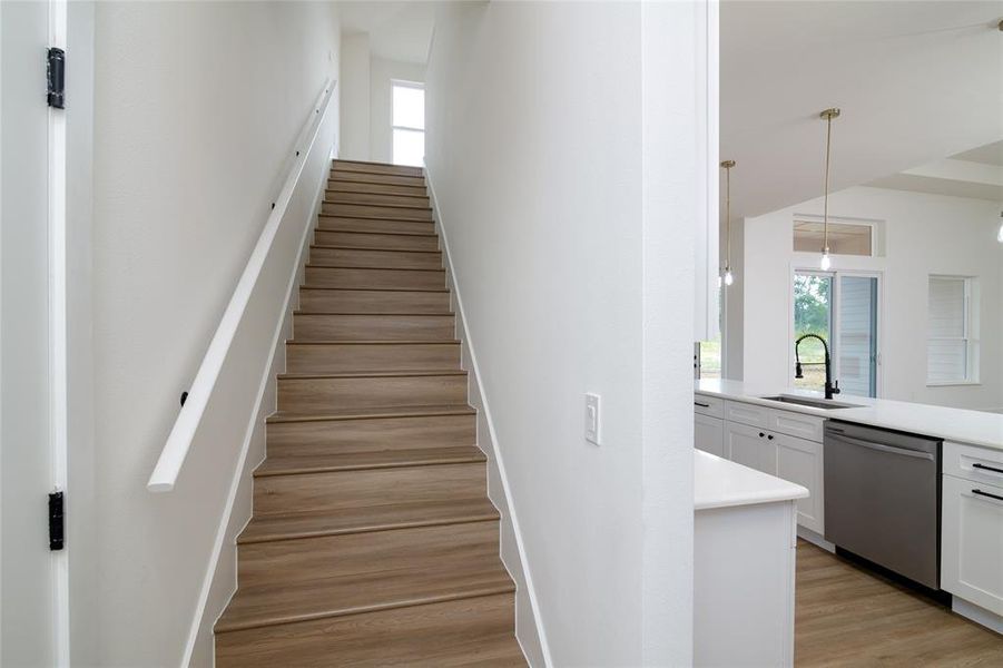 Up-Stairs featuring wood-type flooring and sink