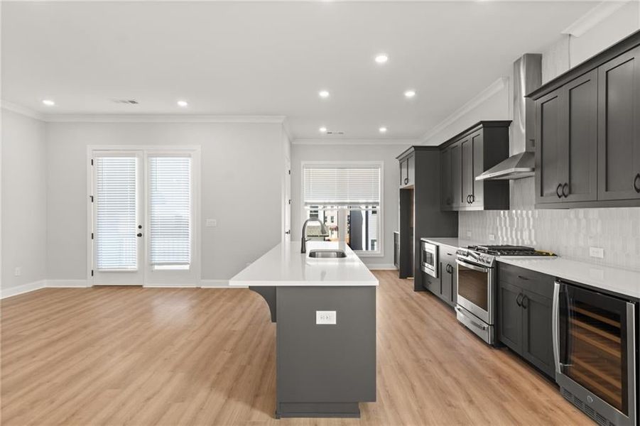 Homesite 13 features stacked white cabinets at the perimeter and an Ebony colored island. NOT actual home. Photos of previously built Grayton floorplan.