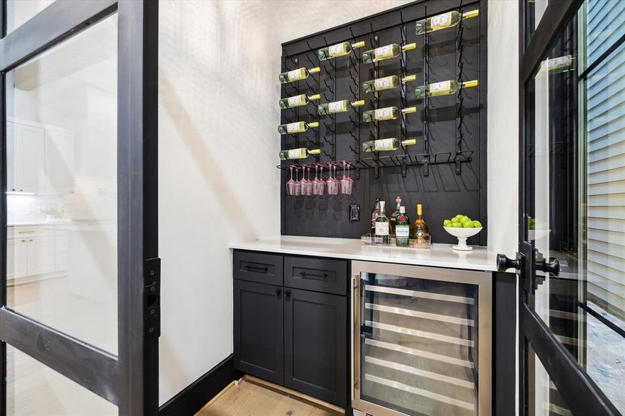 The Wine Grotto is entirely enclosed with the ability to add climate control. There is a 72 Bottle Wine Rack, Slab Quartz Counter, Under-Counter Storage Cabinet, and a Zephyr Wine Cooler with a 53 bottle Capacity.