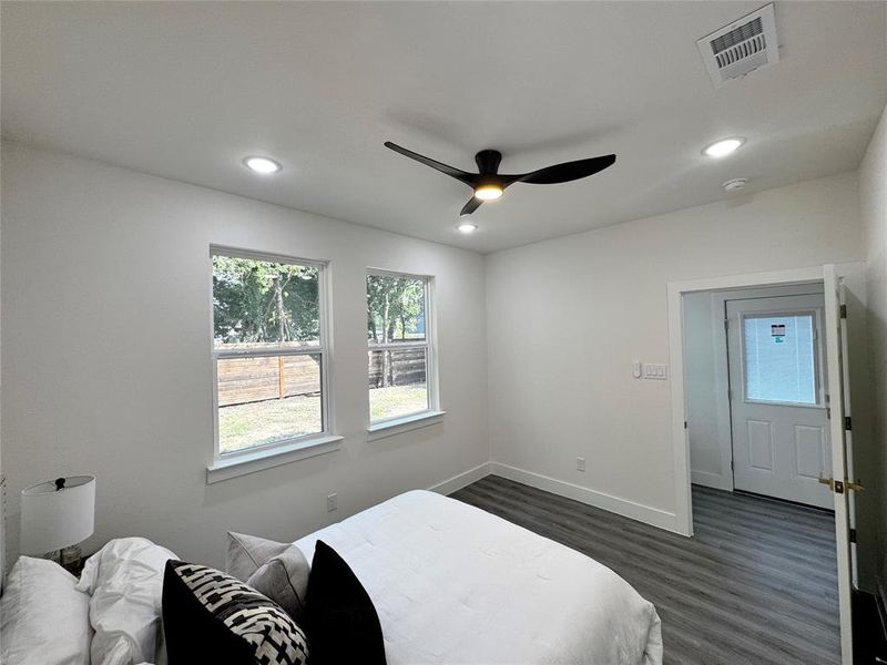 Bedroom with dark wood-type flooring and ceiling fan