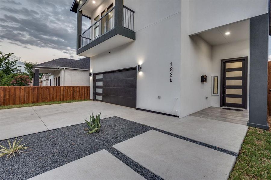 Modern concrete slab walkway leading to the front door.