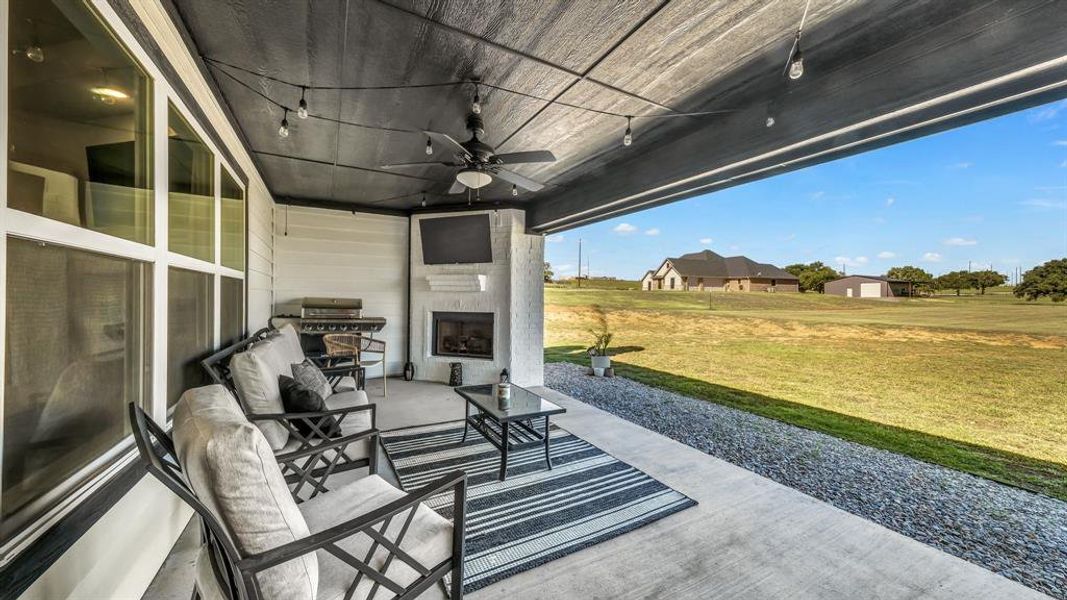 Back patio featuring wood burning fireplace