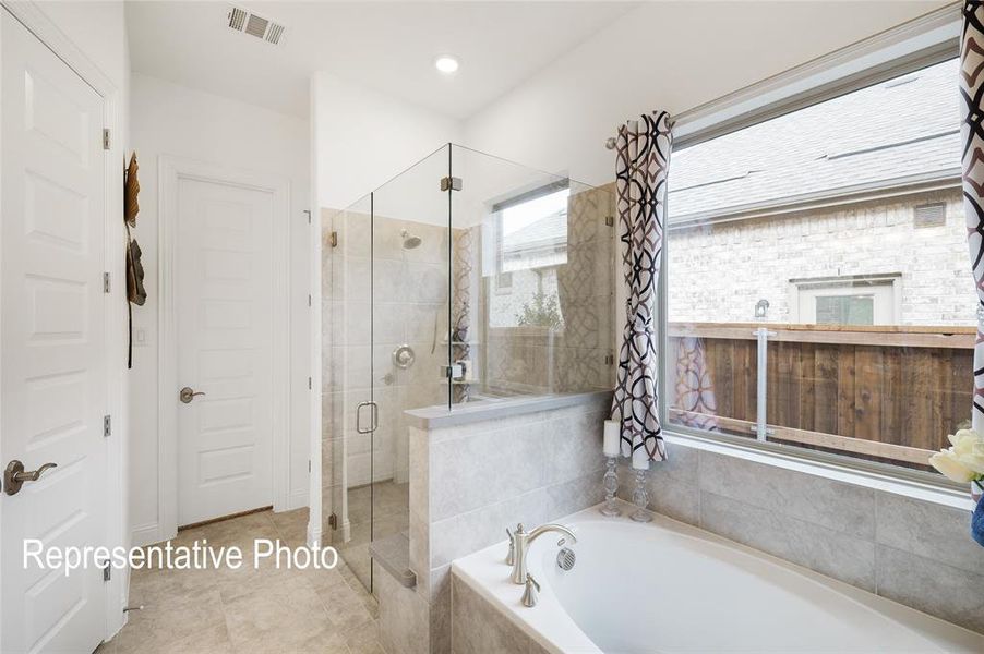 Bathroom featuring tile flooring and plus walk in shower