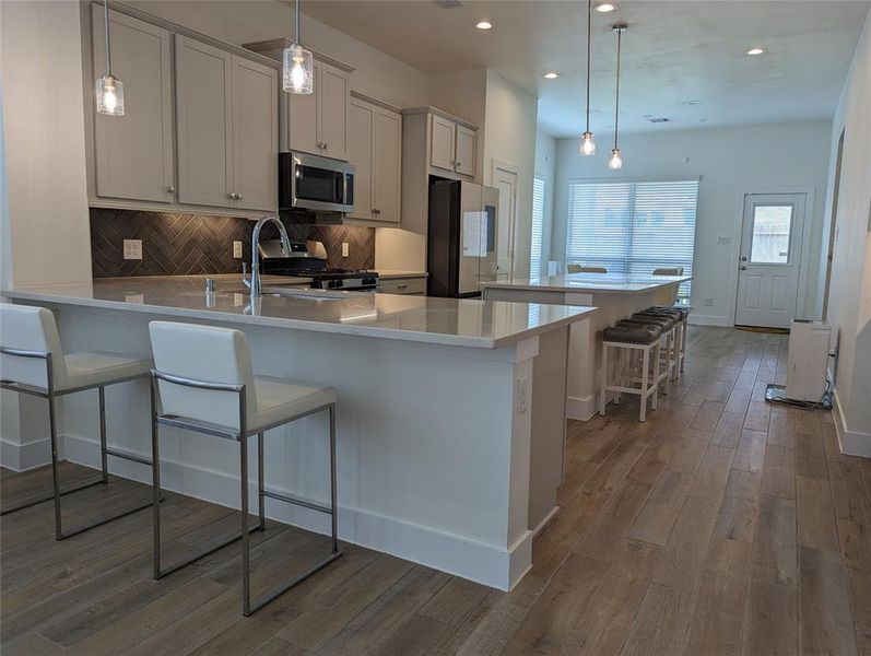 Large Spacious kitchen with l-shape counters and cabinets with a island and additional seating