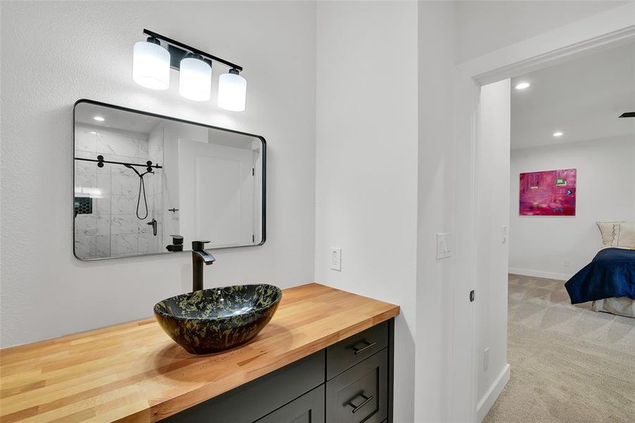 Custom sink with vanity and tiled shower