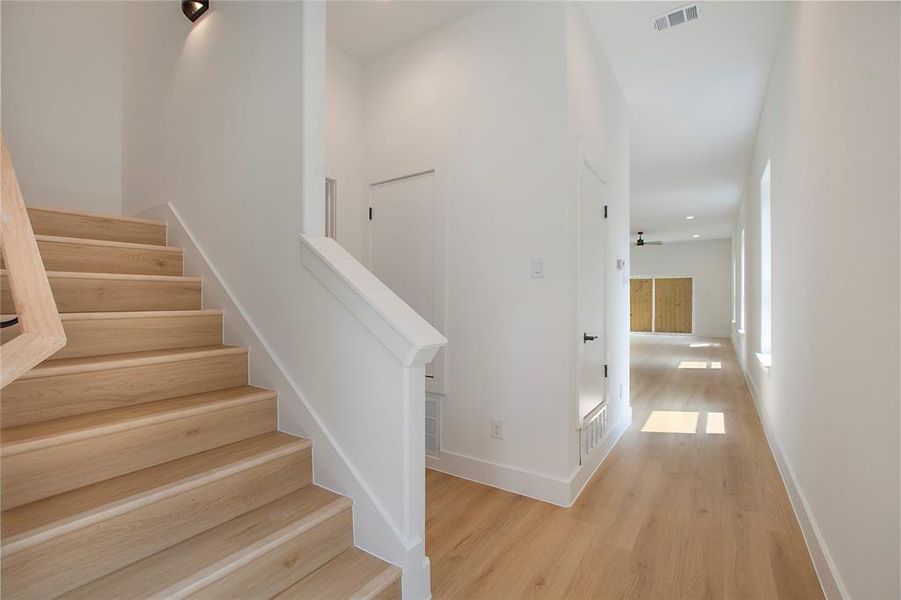 Stairs with hardwood / wood-style flooring