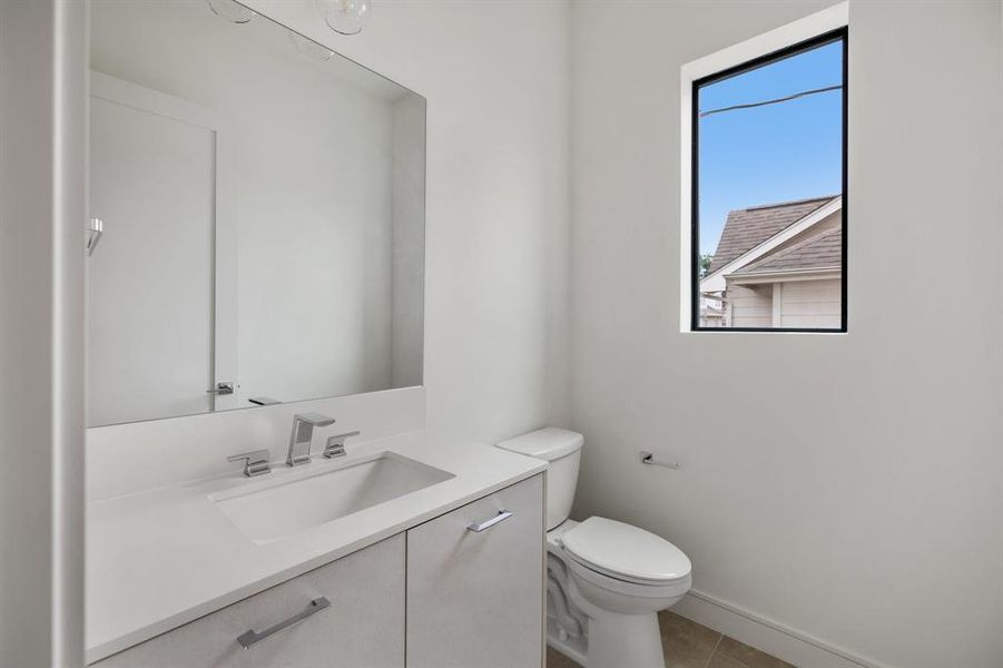 The powder bathroom is tucked away on the second floor and features neutral finishes.