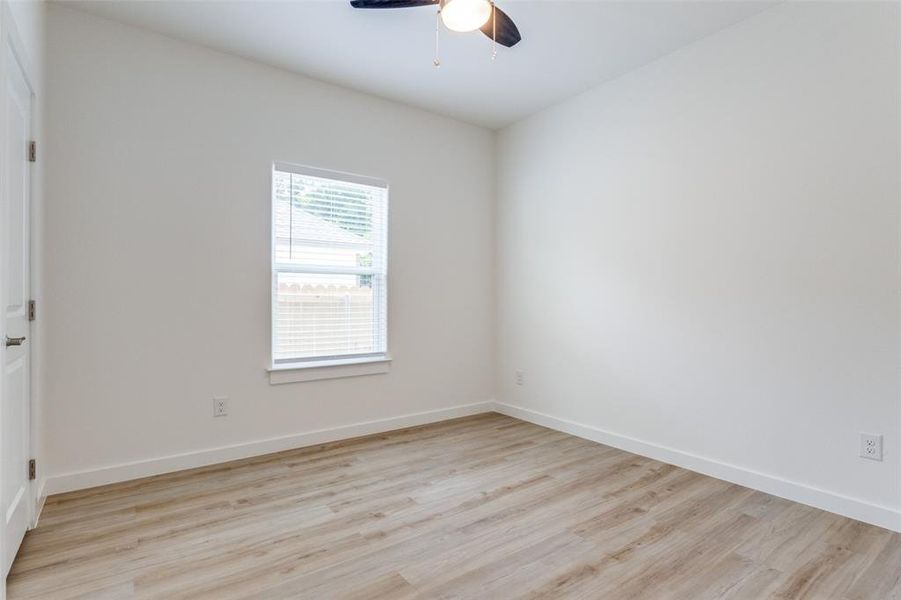 Empty room featuring light hardwood / wood-style floors and ceiling fan