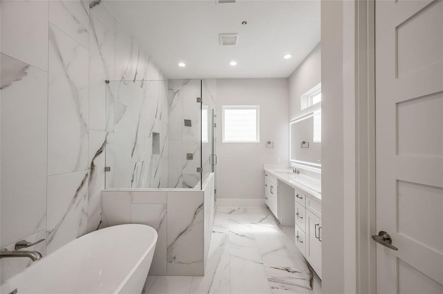 The primary bath is very luxurious and features a freestanding soaking, double sink vanity and oversized shower.