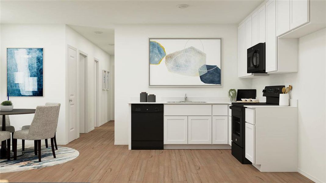 Kitchen featuring white cabinets, light wood-type flooring, sink, and black appliances