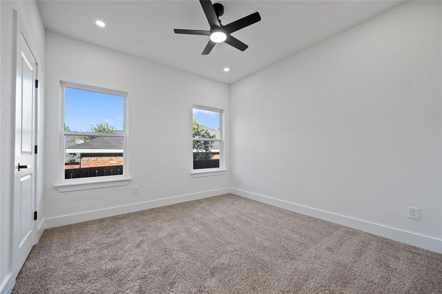 Spare room featuring carpet floors and ceiling fan