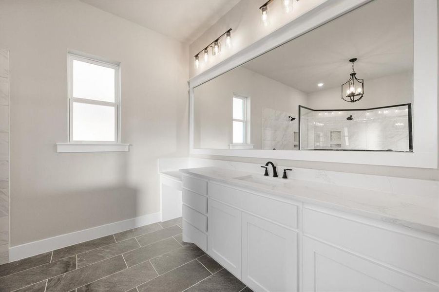 Bathroom with vanity, tiled shower, a notable chandelier, and tile patterned floors