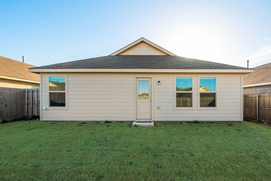 Rear view of house with a yard