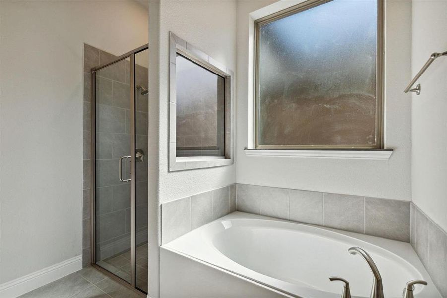 Bathroom with tile patterned flooring and separate shower and tub